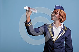 Stewardess airplane ready to launch paper plane