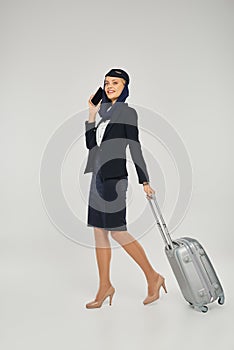 stewardess in arabian airlines uniform walking