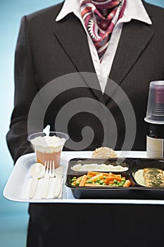 Stewardess Holding Tray With Airplane Food