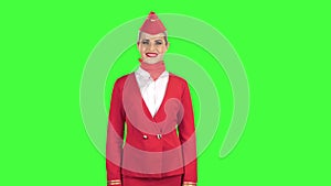 Stewardess looks up and smiles. Green Screen