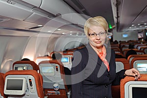 Stewardess near armchairs photo