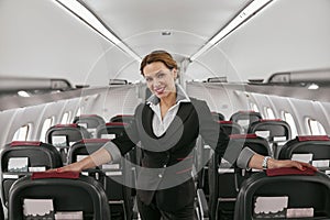 Stewardess in passenger cabin of airplane jet