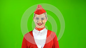 Stewardess in a red suit takes off her sunglasses. Green Screen