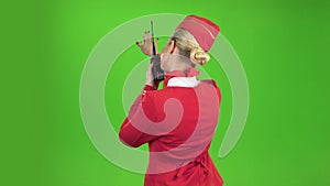 Stewardess speaks on the walkie talkie. Green screen. Back view