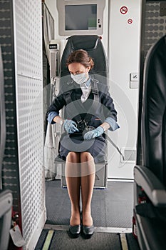 Stewardess use seat belt of passenger airplane jet