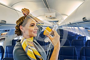 Stewardess using a breathing apparatus during a pre-flight safety demonstration