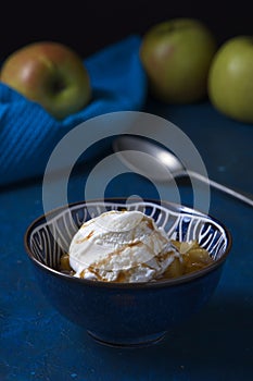 Stewed apple in sweet sauce with ice-cream with fresh apples