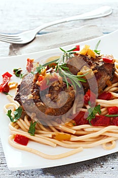 Stewed beef with pasta and vegetables photo