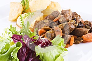 Stewed beef steak with potatoes and salad photo