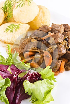 Stewed beef steak with potatoes and salad