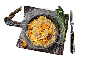 Stewed cabbage Bigos with mushrooms and sausages. Isolated on white background, Top view.