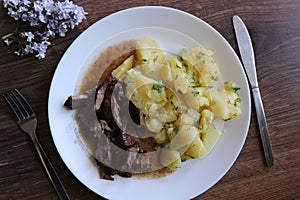 stewed kindeys witch potatoes on the wooden table