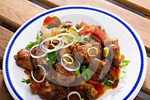 Stewed meat with vegetables and mushrooms