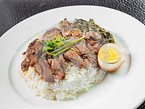 Stewed pork leg on rice with boiled egg and preserve