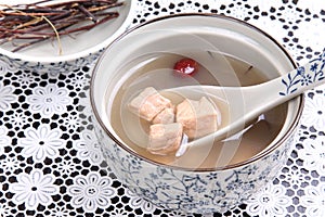 Stewed soup of pork in bowl in chinese style with herbs