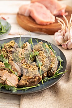 Stewed turkey fillet with sprouts of green peas on white wooden background. Side view, selective focus