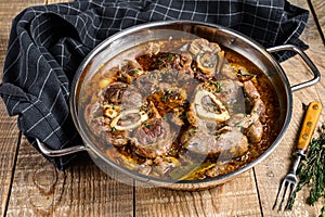 Stewed veal shank meat Osso Buco, italian ossobuco steak. wooden background. Top view photo