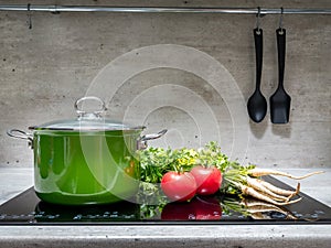 Stewpot with vegetables on induction cooker