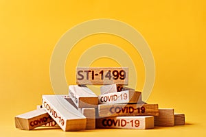 STI-1499 antibody concept. wooden blocks labeled covid-19 and blocks labeled STI-1499.
