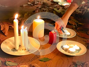 stic candles on the wooden platform with aurumn leaves