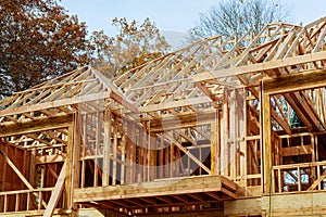 A stick built house under construction New build roof with wooden and beam framework.