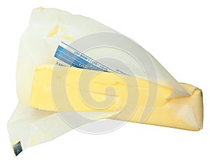 Stick of Butter in Paper Unwrapped Over White