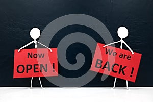 Stick man figures holding We are Back and Now Open red signage. Business and shop reopening.