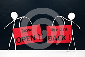 Stick man figures holding We are Back and Now Open red signage. Business and shop reopening after covid-19 pandemic concept.