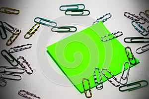 Sticker with adhesive base and small multicoloured paperclips