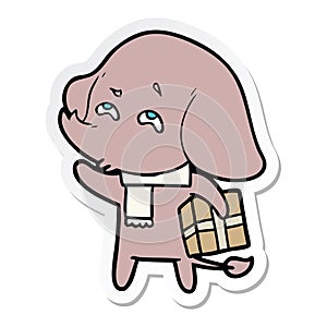 sticker of a cartoon elephant with gift remembering