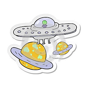 sticker of a cartoon flying saucer in space