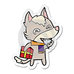 sticker of a cartoon hungry wolf holding christmas present