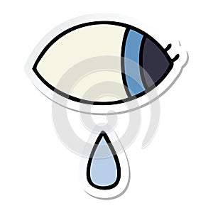 sticker of a cute cartoon crying eye looking to one side