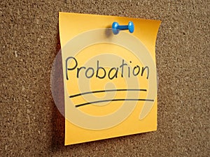The sticker with the inscription Probation is pinned to the board.