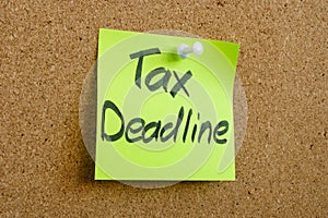 A sticker with the inscription tax deadline is pinned to the board.