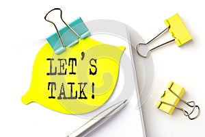 Sticker with LET`S TALK text on notebooks on the white background