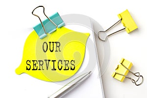 Sticker with OUR SERVICES text on notebooks on the white background