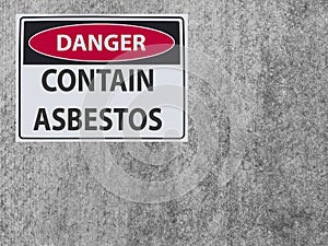 The sticker Sign danger asbestos contain at the plaster asbestos wall
