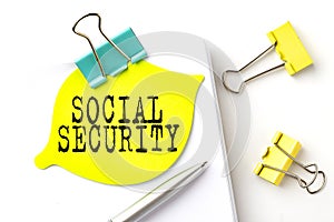 Sticker with SOCIAL SECURITY text on notebooks on the white background