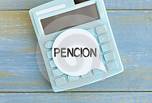 A sticker with the text PENSION lies on the calculator.