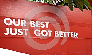 Sticker white color word is a Our best just got better on red wall for succession service industry business and commercial