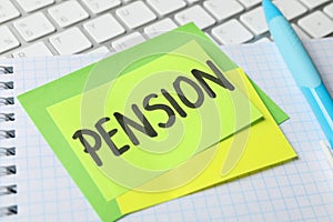 Stickers with inscription Pension on workplace background