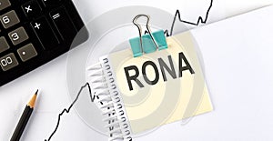 Stickers with pencils and notebook with text RONA on wooden background photo