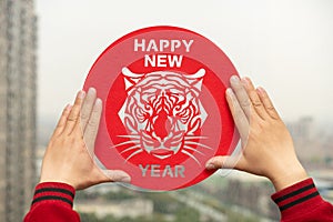 sticking Chinese New Year of tiger 2022 mascot to the window translation of the Chinese is happy new tiger year