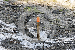 Sticking out of the ground and snow rusted rebar