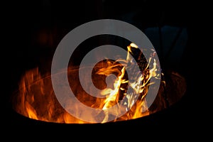 Sticks burning in a large metal bowl