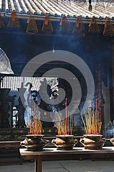 Sticks of incense are burning in a buddhist temple in Saigon (Vietnam) photo