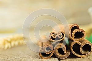 Sticks and powder aroma cinnamon on old wooden background