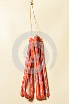 Sticks salami or sausages hanging on the ropes.