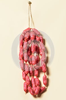 Sticks salami or sausages hanging on the ropes.